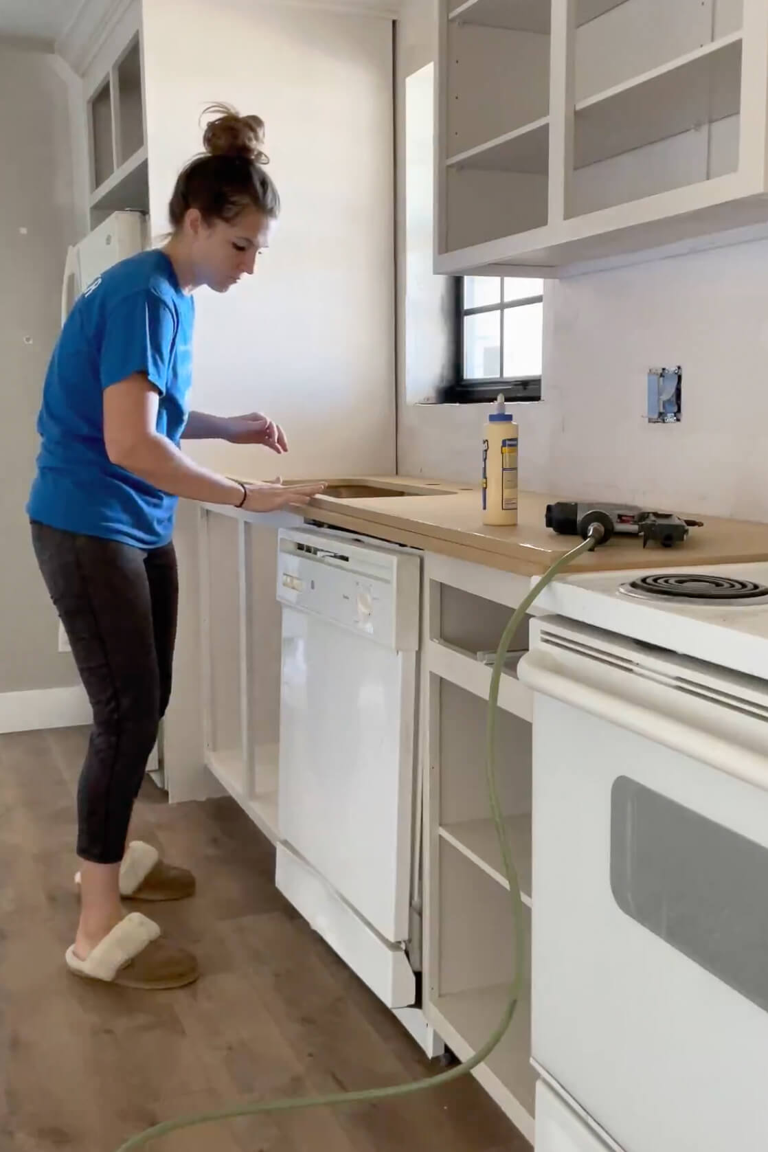 Using wood glue to attach the edge of the DIY countertop.